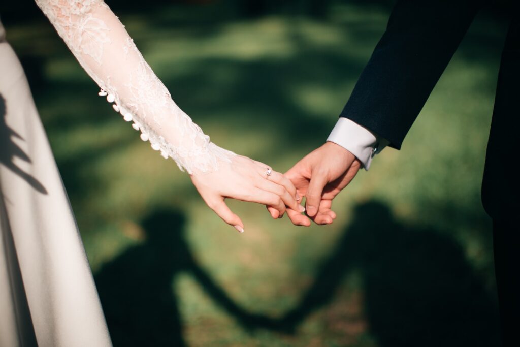 bride and groom holding hands